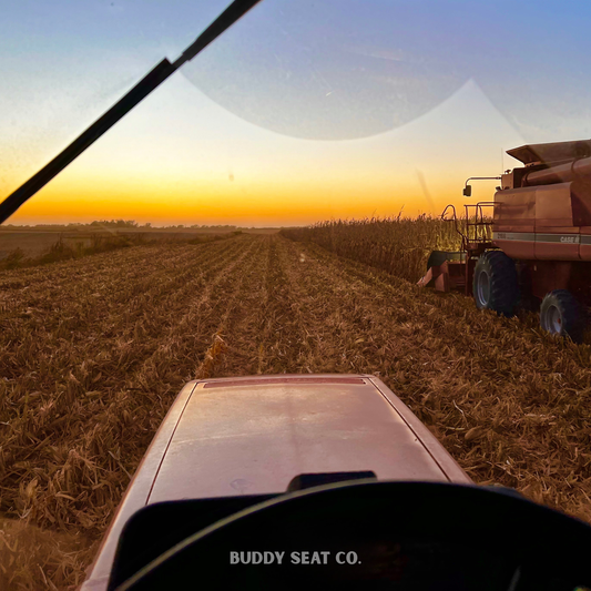 Iowa harvest at sunset - view from the tractor and grain cart while combining corn. 