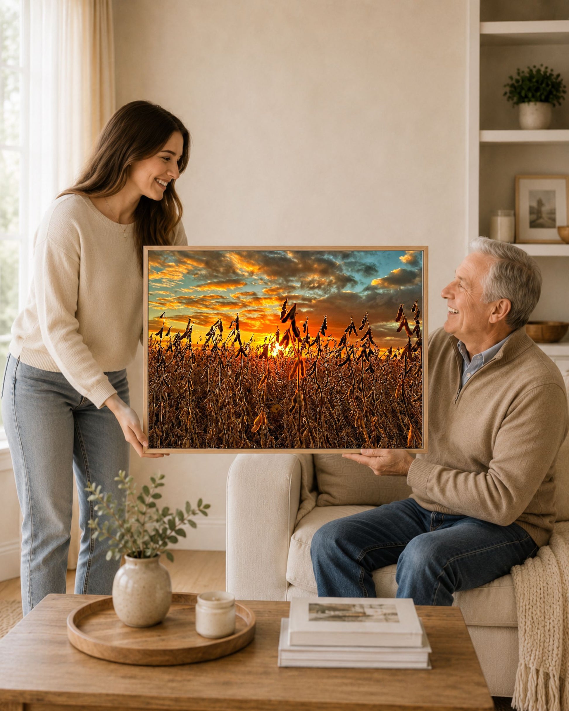 Daughter gifting framed soybean field sunset canvas wall art to her father in a warm living room setting.