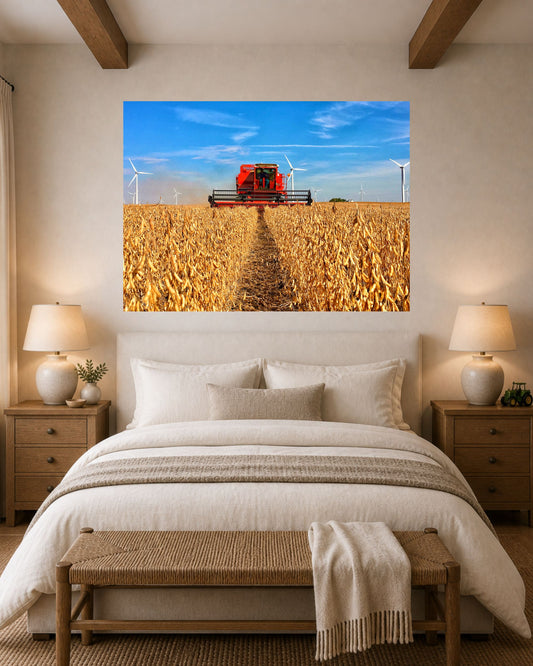 Vintage red International combine harvesting soybeans canvas wall art displayed above a bed in a warm neutral farmhouse-style bedroom.