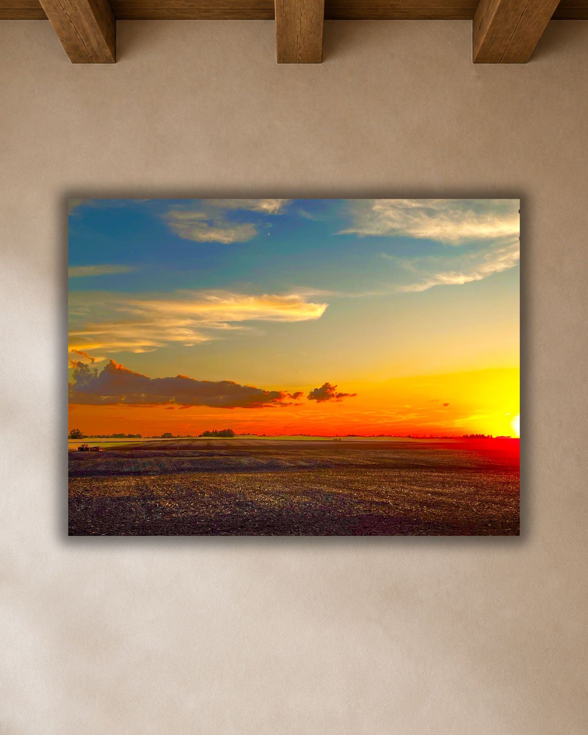 Rural Iowa sunset field canvas wall art displayed above a wood dining table in a warm farmhouse breakfast nook.
