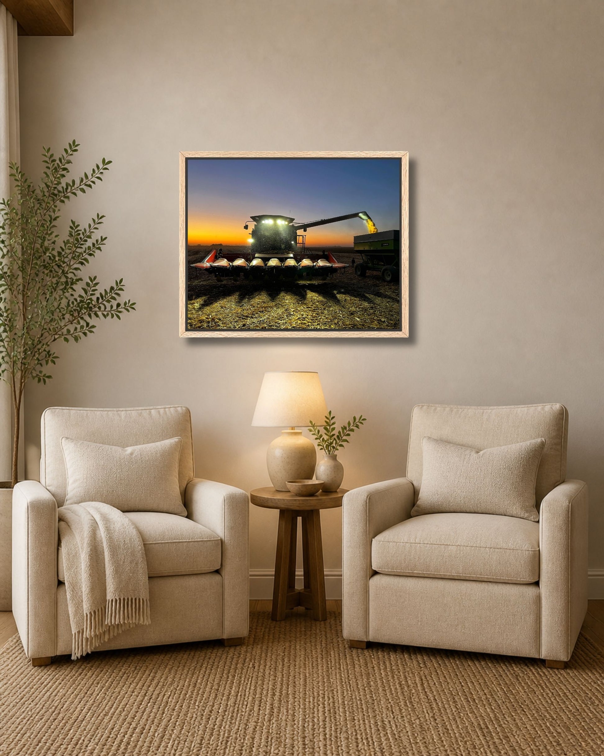 Walnut framed combine harvest sunset artwork displayed above a wood console table in a farmhouse entryway.