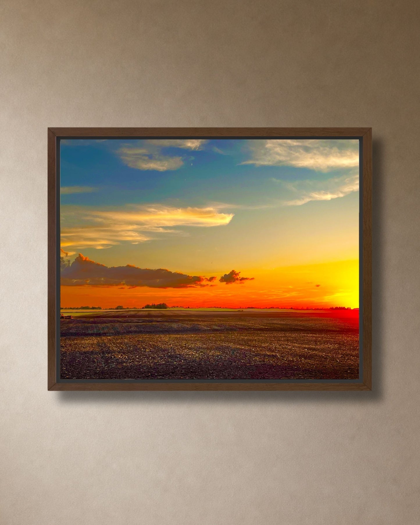 Golden farmland sunset canvas wall art styled above a stone fireplace in a warm modern farmhouse living room.
