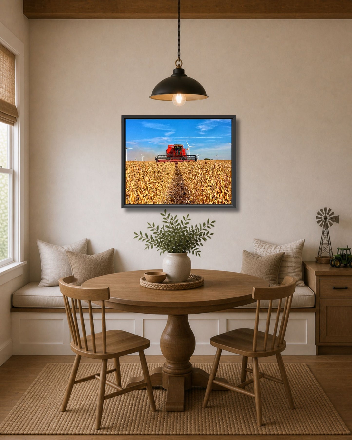 Black framed soybean harvest wall art displayed above a breakfast nook table in a warm modern farmhouse interior.