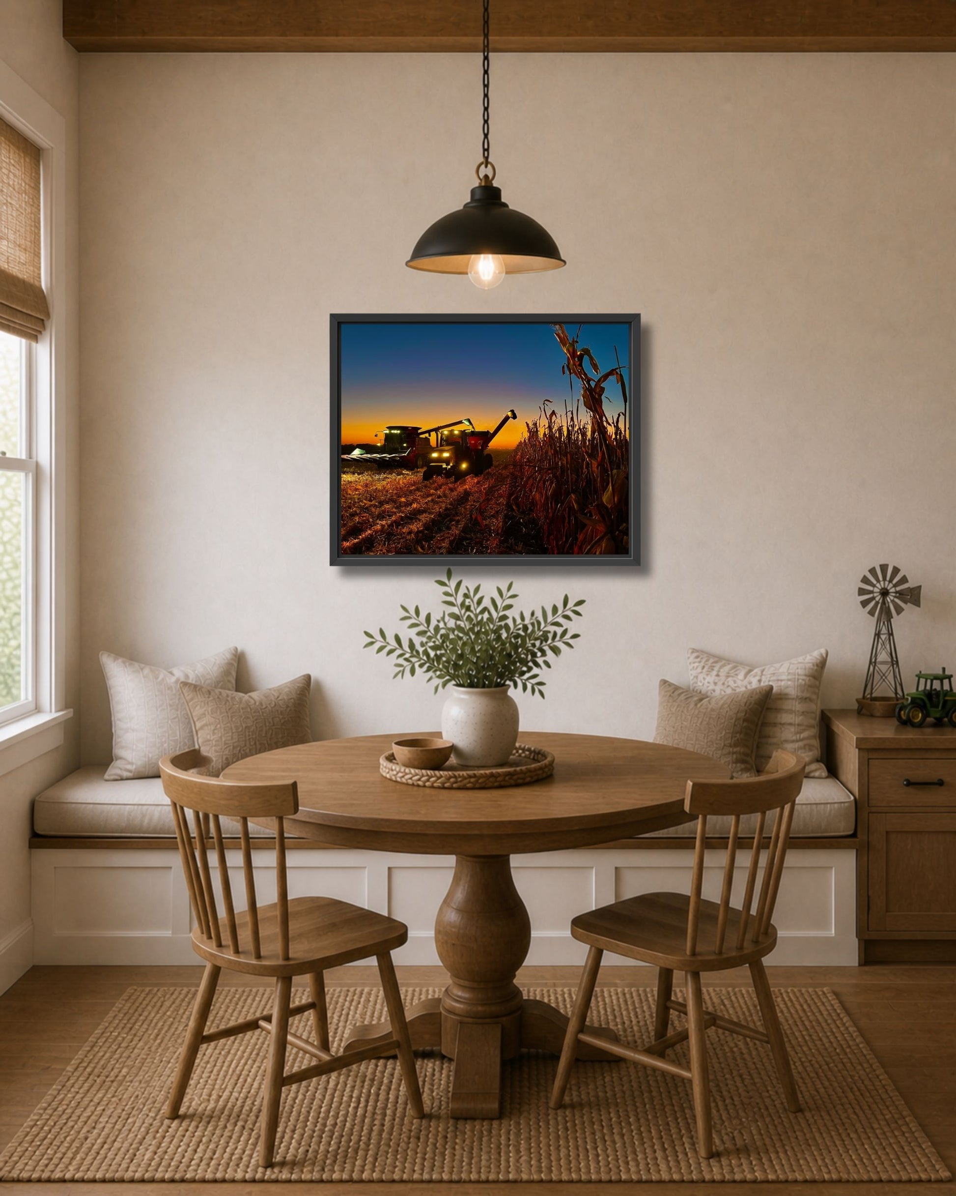 Black framed corn harvest wall art displayed above a breakfast nook table in a warm modern farmhouse interior.
